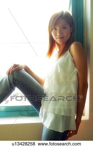 Leaning in a window sill View Large Photo Image Stock Photo - Leaning in a window sill . Fotosearch