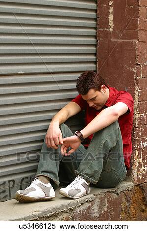 Man sitting on a brick doorway View Large Photo Image Stock Photography - Man sitting on a brick doorway. Fotosearch