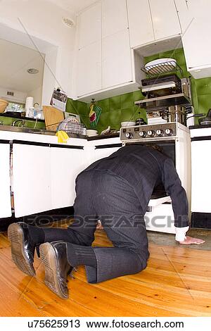 Man with his head in the oven View Large Photo Image Stock Image - Man with his head in the oven . Fotosearch