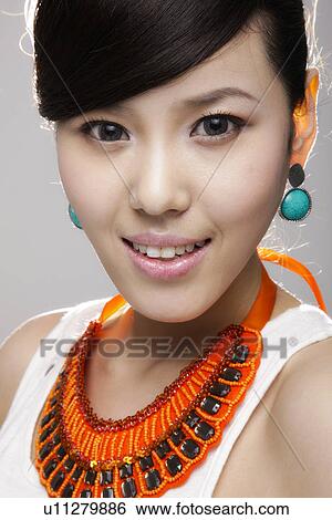 Stock Photograph - Model with a large necklace . Fotosearch