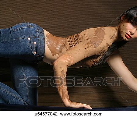 Stock Image - Mud covered woman crawling . Fotosearch
