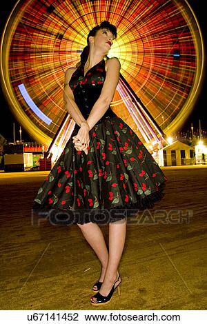 Stock Image - Pin up in front of a ferris wheel . Fotosearch