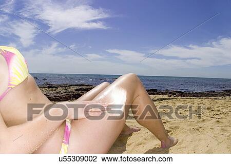Stock Image - Putting sunscreen on . Fotosearch