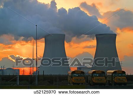 Stock Image - School buses outside of a power plant . Fotosearch