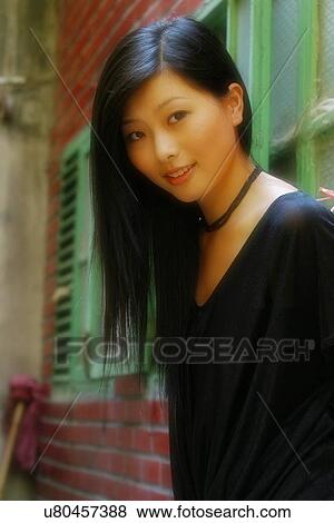 Smiling woman by a brick wall View Large Photo Image Stock Photo - Smiling woman by a brick wall . Fotosearch