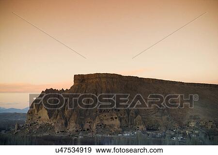 Sunset behind a rock formation View Large Photo Image Stock Photo - Sunset behind a rock formation . Fotosearch