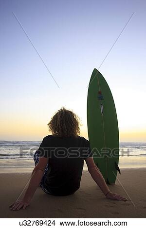 Picture - Surfer looking at the ocean . Fotosearch