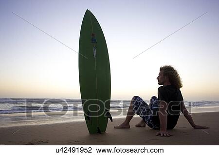 Stock Image - Surfer taking a rest . Fotosearch