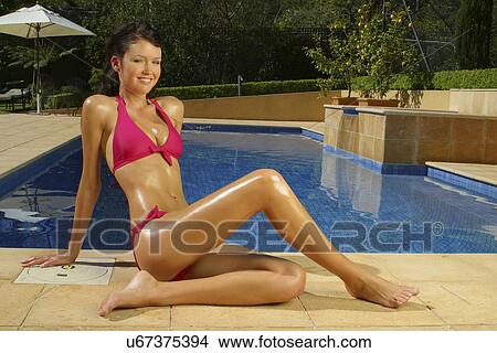 Picture - Thin woman in a bikini by the pool . Fotosearch