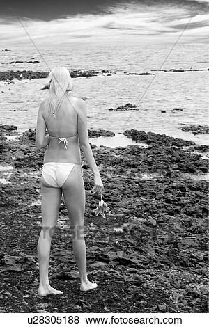 Walking on a rocky beach View Large Photo Image Stock Photo - Walking on a rocky beach . Fotosearch