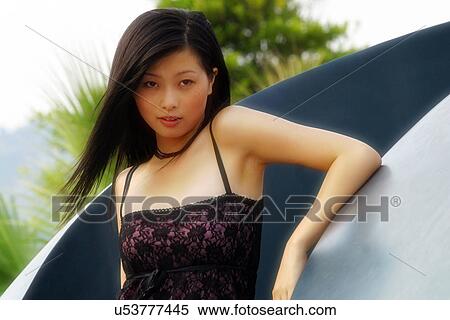 Stock Photography - Woman leaning on statue . Fotosearch