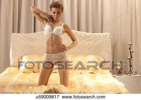 Woman on a bed View Large Photo Image Stock Photo - Woman on a bed. Fotosearch