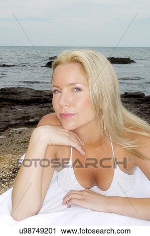 Woman resting her head on her hand View Large Photo Image Stock Image - Woman resting her head on her hand . Fotosearch