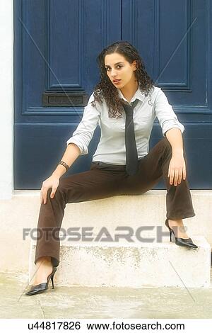 Woman sitting on steps View Large Photo Image Stock Photograph - Woman sitting on steps. Fotosearch