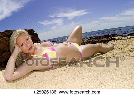 Woman sunbathing in a colorful bikini View Large Photo Image Stock Photograph - Woman sunbathing in a colorful bikini . Fotosearch