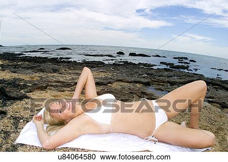 Stock Image - Woman sunbathing . Fotosearch