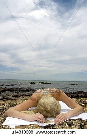 Stock Photo - Woman sunbathing . Fotosearch