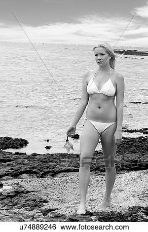 Woman walking on the beach View Large Photo Image Stock Photograph - Woman walking on the beach . Fotosearch