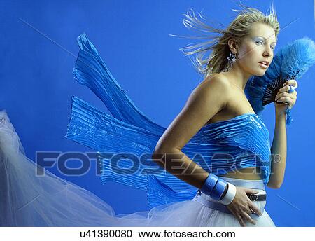 Woman with blue fan View Large Photo Image Stock Image - Woman with blue fan . Fotosearch