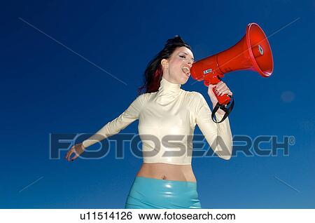 Stock Photograph - Woman yelling in a megaphone . Fotosearch