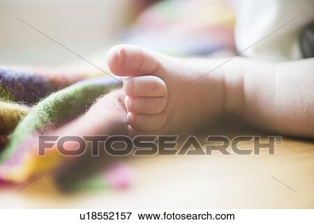 Stock Photo - Baby boy's foot, close up. Fotosearch