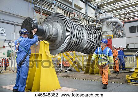 Stock Image -  Banksman and crane operator lowering crane to turbine hall during power station outage. Fotosearch