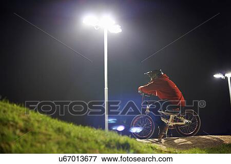 BMX-cyclist riding at night time View Large Photo Image Stock Photo - BMX-cyclist riding at night time. Fotosearch