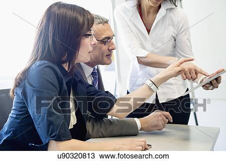 Stock Image - Businessman and women in discussion. Fotosearch