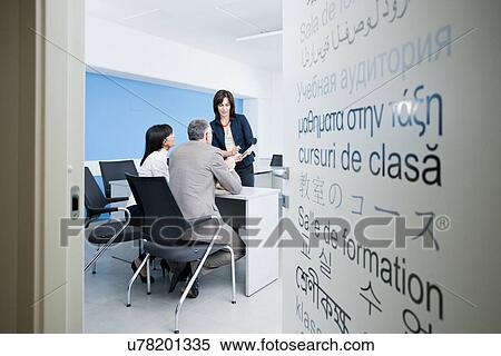 Stock Photography - Businessman and women in discussion. Fotosearch