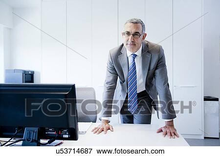 Stock Photo - Businessman at office desk. Fotosearch