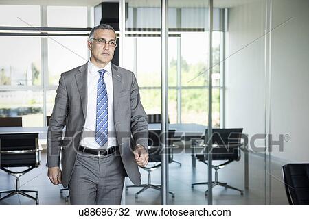 Stock Image - Businessman exiting meeting room. Fotosearch