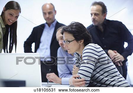 Stock Image - Businesspeople in brainstorming meeting. Fotosearch