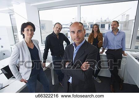 Stock Photograph - Businesspeople posing for group portrait in office. Fotosearch