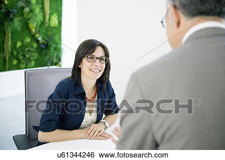 Businesswoman and man chatting View Large Photo Image Stock Photograph - Businesswoman and man chatting. Fotosearch