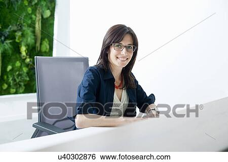 Businesswoman at office desk View Large Photo Image Stock Photograph - Businesswoman at office desk. Fotosearch