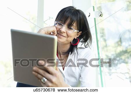 Businesswoman using digital tablet View Large Photo Image Stock Photo - Businesswoman using digital tablet. Fotosearch