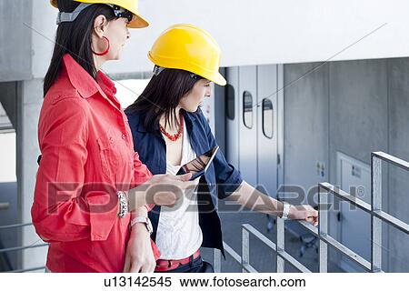 Businesswomen in safety helmet at balcony View Large Photo Image Stock Photography - Businesswomen in safety helmet at balcony. Fotosearch
