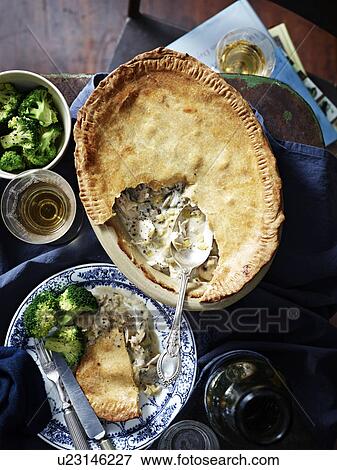 Stock Photo - Chicken leek mushroom pie, broccoli and wine. Fotosearch