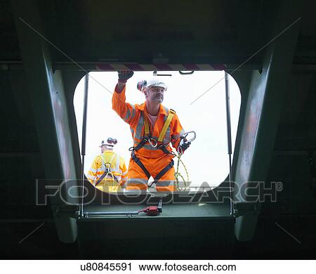Stock Image - Civil engineers inspecting structure under carriageway of suspension bridge. The Humber Bridge, UK, built in 1981 was the world's largest single-span suspension bridge. Fotosearch