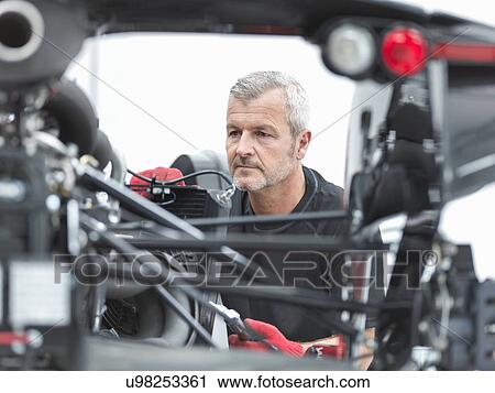 Close up of engineer assembling supercar in sports car factory View Large Photo Image Stock Image - Close up of engineer assembling supercar in sports car factory. Fotosearch