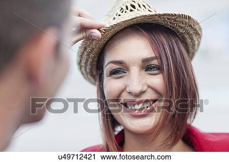 Close up of man holding young woman's straw hat View Large Photo Image Stock Image - Close up of man holding young woman's straw hat. Fotosearch
