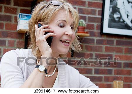 Close up of mature woman chatting on smartphone View Large Photo Image Stock Photo - Close up of mature woman chatting on smartphone. Fotosearch