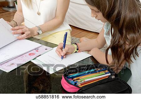 Close up of mother and daughter writing on notepad View Large Photo Image Stock Photograph - Close up of mother and daughter writing on notepad. Fotosearch