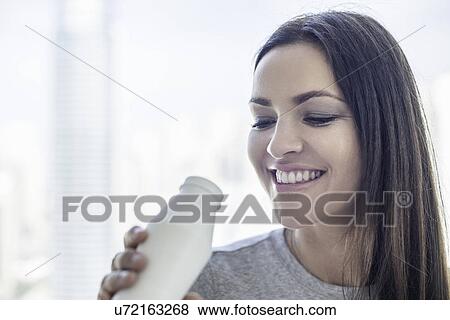 Close up of young woman drinking milk View Large Photo Image Stock Photo - Close up of young woman drinking milk. Fotosearch
