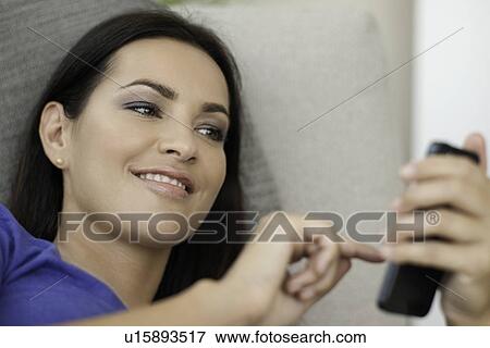 Close up of young woman texting on smartphone View Large Photo Image Stock Photo - Close up of young woman texting on smartphone. Fotosearch