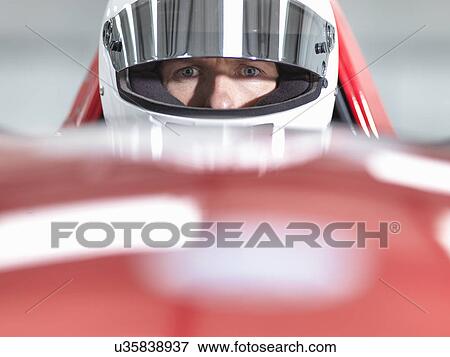 Close up portrait of racing car driver wearing helmet in supercar View Large Photo Image Stock Photo - Close up portrait of racing car driver wearing helmet in supercar. Fotosearch