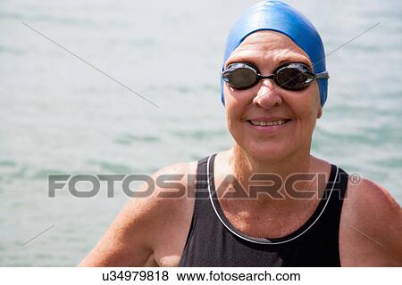 Stock Photo - Close up portrait of senior woman swimmer in sea. Fotosearch