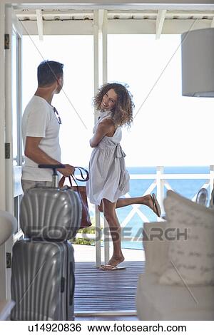 Couple fooling around at beach house apartment View Large Photo Image Stock Photograph - Couple fooling around at beach house apartment. Fotosearch