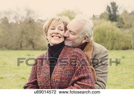 Stock Image - Couple hugging, man leaning on woman's shoulder. Fotosearch