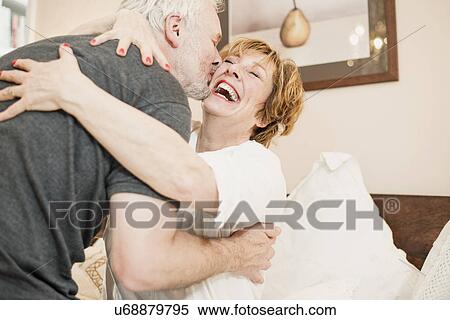 Couple hugging, mature woman laughing View Large Photo Image Stock Photography - Couple hugging, mature woman laughing. Fotosearch